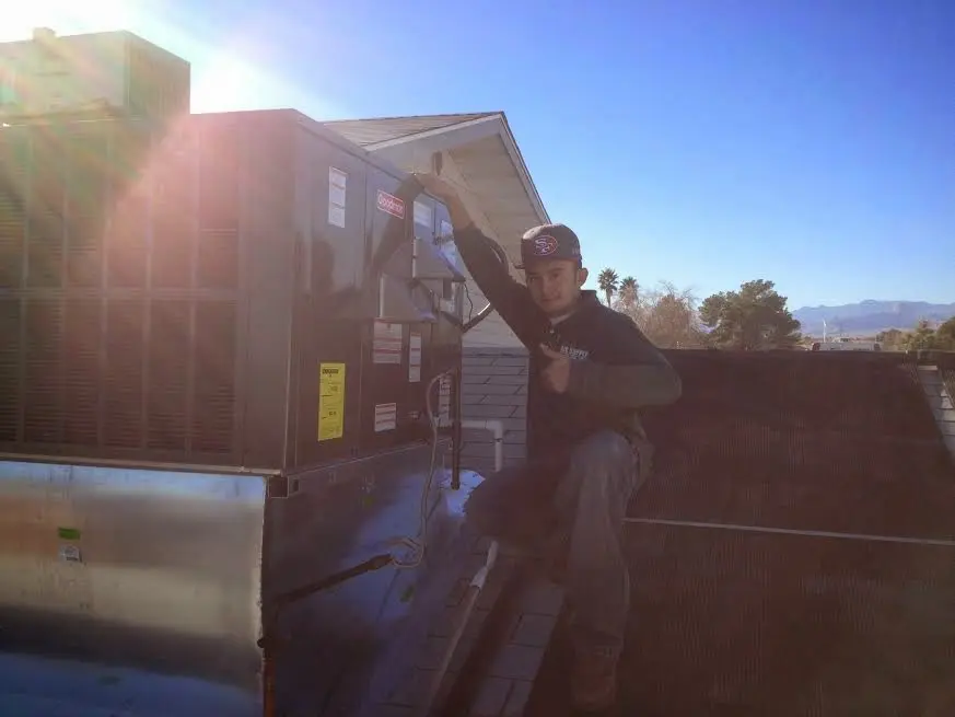 HVAC technician performing Air Duct Repair on a rooftop unit in Richfield